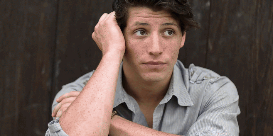 man sits worried about his job or school and thinking about his options